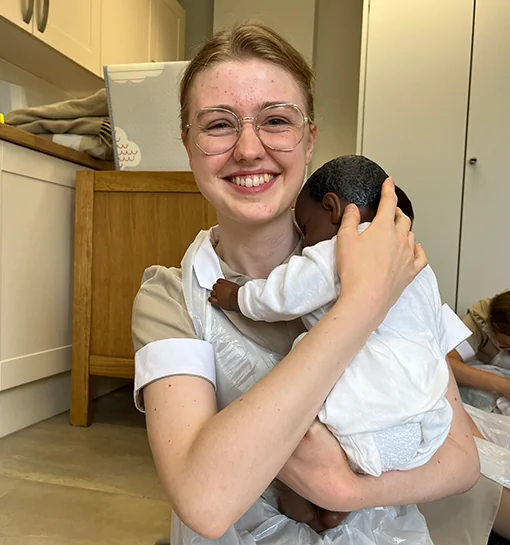 Norland student holding virtual baby doll
