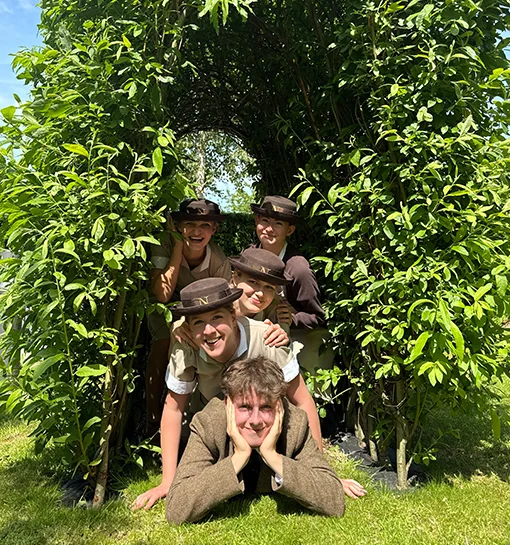 Norland students in uniform posing in garden