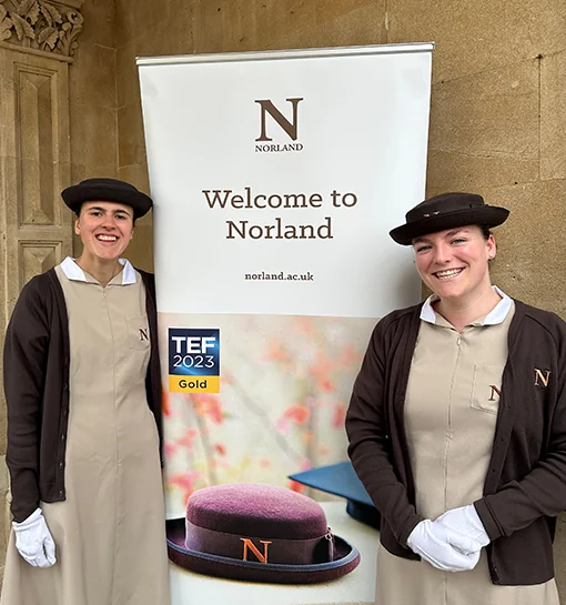 Norland students at an open day stood by a welcome sign