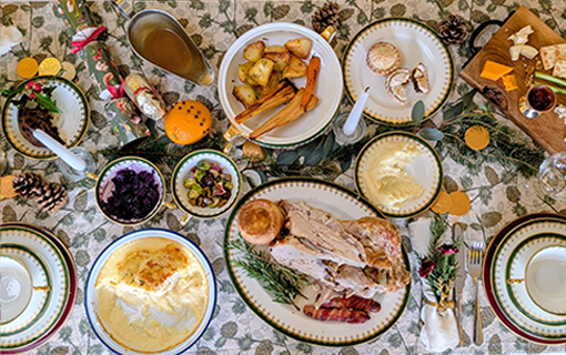 Christmas Dinner spread on table with food and plates