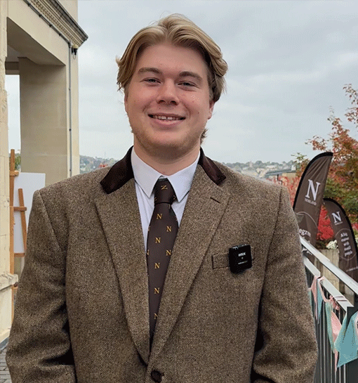 Male Norland student in formal uniform outside smiling to camera