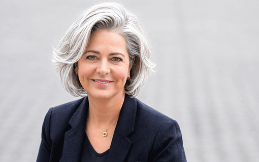 Smiling woman to camera with blue suit on