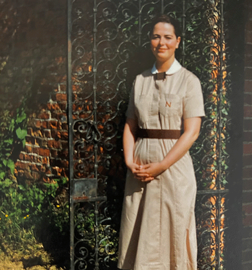 Photograph of Norland student from 1995 outside of gate