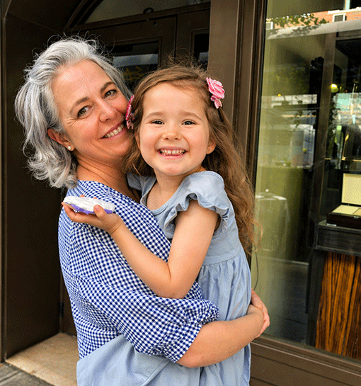 Norland Nanny of the Year Colette holding her daughter smiling