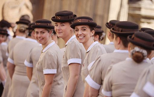 Norland students at graduation in uniform lined up smiling