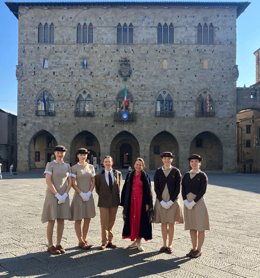 Norland students in uniform in Pistoia Italy posing in a square