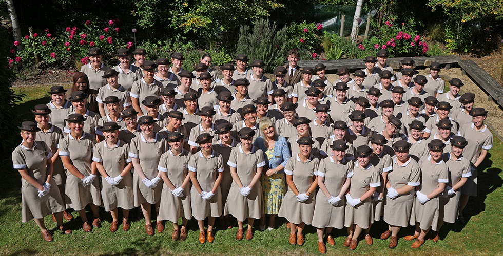 Set 147 Norland students in formal uniform posing for group picture