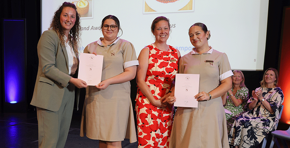 Norland students receiving certificate on stage