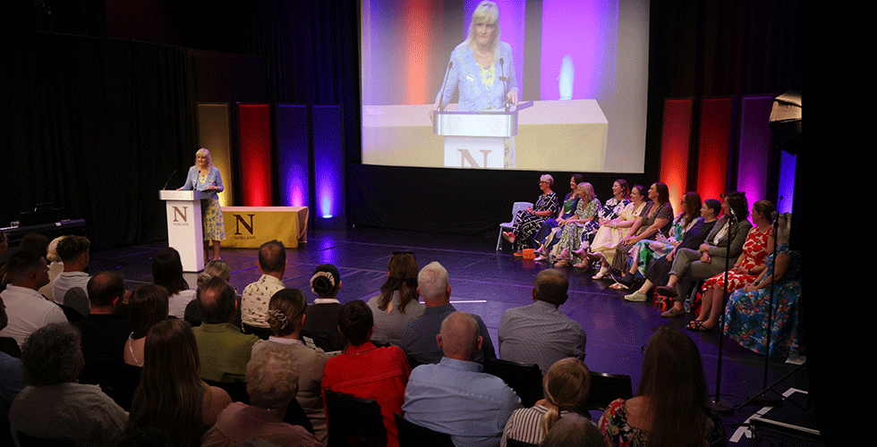 Dr Janet Rose on stage at Norland giving speech at heritage day