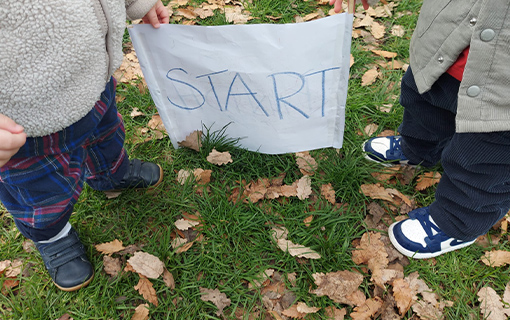 Two children holding a start sign