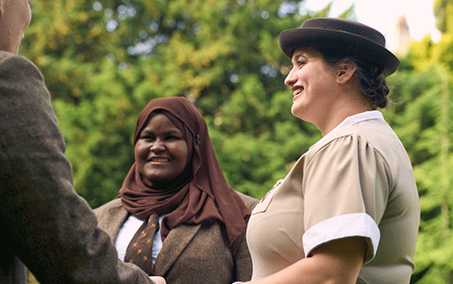 Norland student group in uniform chatting and smiling outside