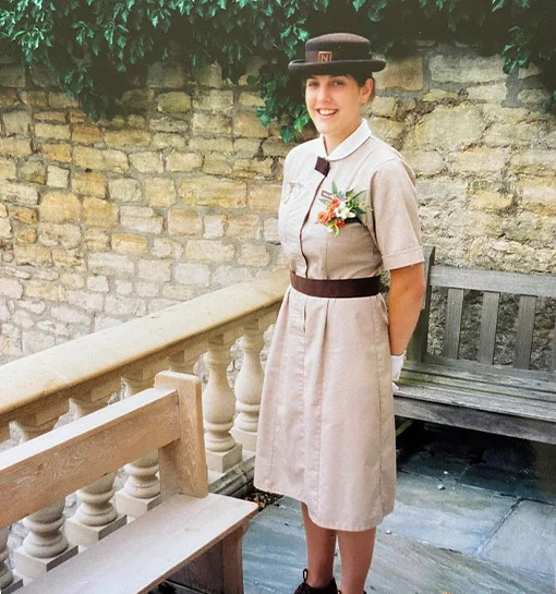 A female Norland Nanny stood in her formal uniform