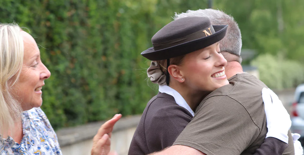 A Norland University student hugging her parents