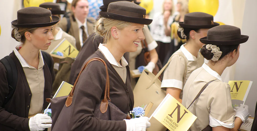 First-year students walking into Norland University of Early Childhood in their formal Norland Nanny uniform on their first day