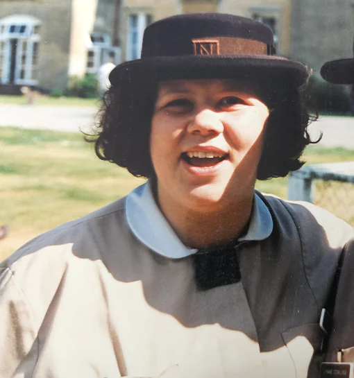 A female Norland Nanny stood in her formal uniform